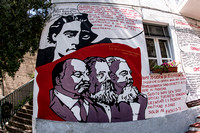 Ogosolo mural copy 1987 Gramsci hovers above Lenin, Engels and Marx as they read the manifesto of the striking metal workers who have occupied their factory. The last sentence reminds the bosses "that
