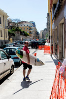 Matt Lewis picking up a board inCagliari, Sardinia